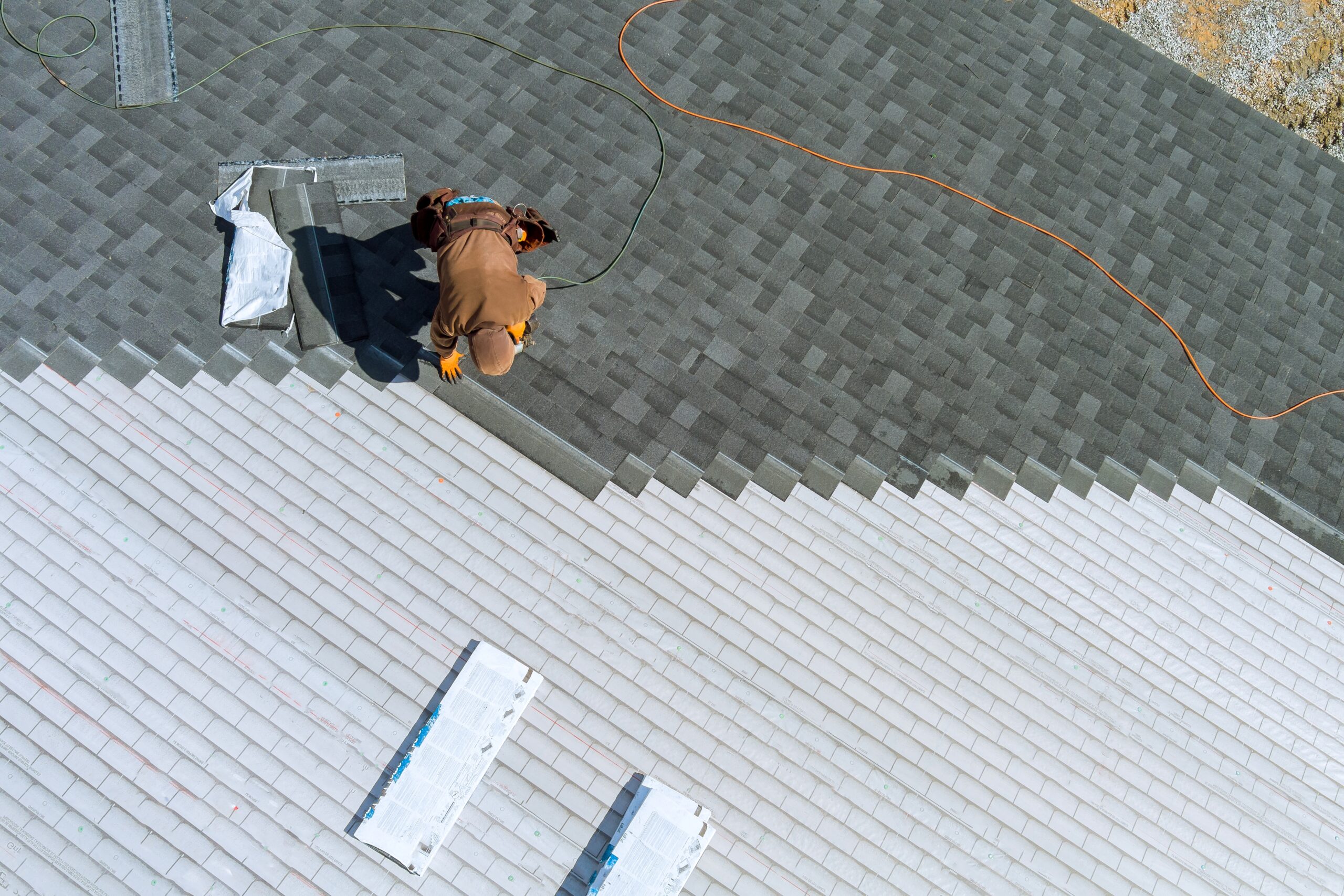 a worker installing shingles on the roof of a home 2023 11 27 05 22 19 utc scaled